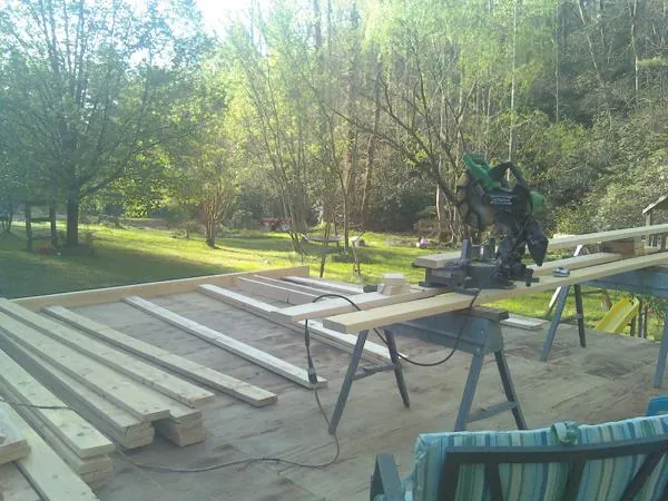 Miter saw and framing lumber on a deck under construction in Salisbury